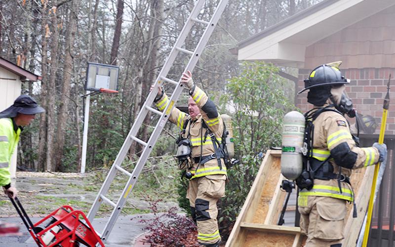 Fannin County firefighters, from left, Assistant Fire Chief Rob Ross, Bill Brown and Matthew Barth were among those battling a fire at 511 Scenic Drive Tuesday morning, March 24.