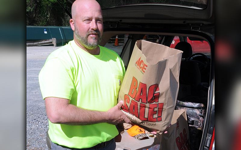 We Are Polk County volunteer Robby Hatcher was at the Polk County Convenience Center in Grassy Creek Saturday passing out bags of groceries to anyone in need.
