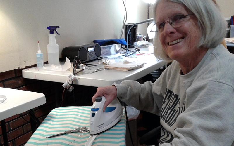 Sue Hoagland makes the seam binding straps for makeshift N95 masks Monday, March 23.