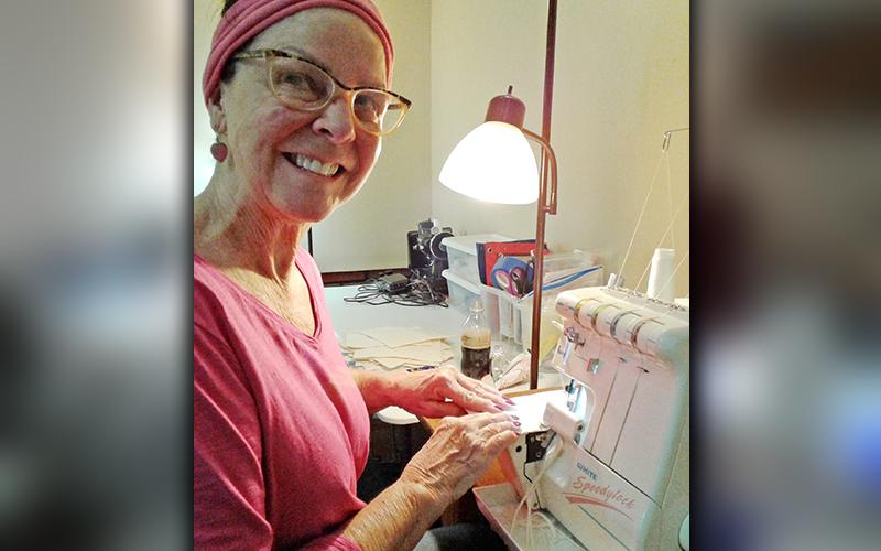 Renee Roberts was among several women to help create masks to alleviate the shortage of N95 masks. She is shown serging a mask.