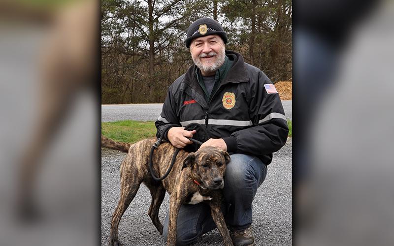 Fannin County Animal Control Manager John Drullinger kneels with this female Plott Hound mix. She was picked up on Sugar Creek Road in Blue Ridge Thursday, February 27 and will be staying at Animal Control until reclaimed or adopted. This sweet girl has a brindle coat with dark cocoa bean eyes. View her under Animal Control number 090-2020.