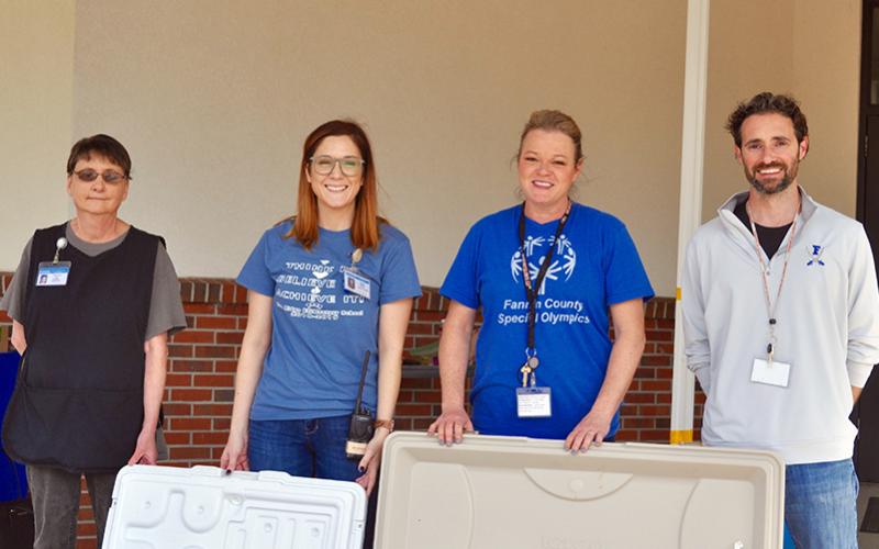 The Fannin County School System is distributing meals to students who need them during the closure caused by COVID-19. Shown distributing meals at Blue Ridge Elementary School are, from left, nutrition staff member Theresa Ray, Parent Liaison Holly Ross, paraprofessional Wendi Hood and Director of Applied &amp; Integrated Instruction Lucas Roof.