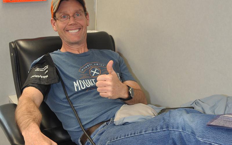 Volunteer Ronnie Holden gives a thumbs up as he gives blood Friday, March 27.