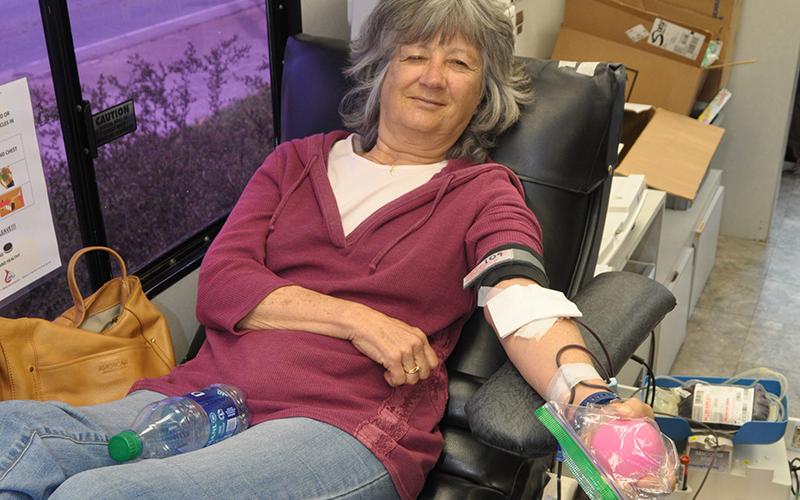 Volunteer Vicky Mauck smiles as she donates blood during the drive at Blue Ridge First Baptist Church Friday, March 27.