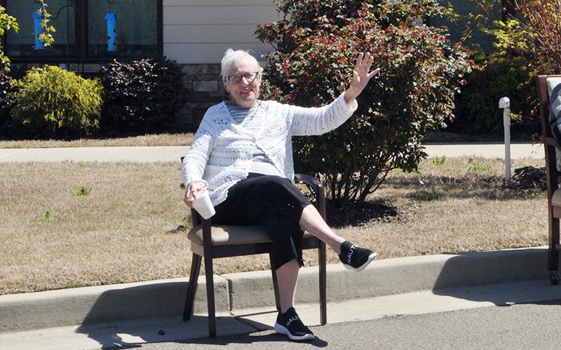 Carolyn Pierce waves as she waits on the parade to start at Blue Ridge Assisted Living &amp; Memory Care Friday, April 3.