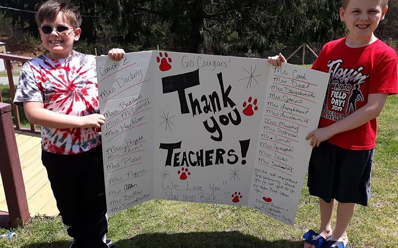 Jax, left, and Brayden Curtis show their teacher appreciation during Copper Basin Elementary School’s Teachers on the Town Parade.