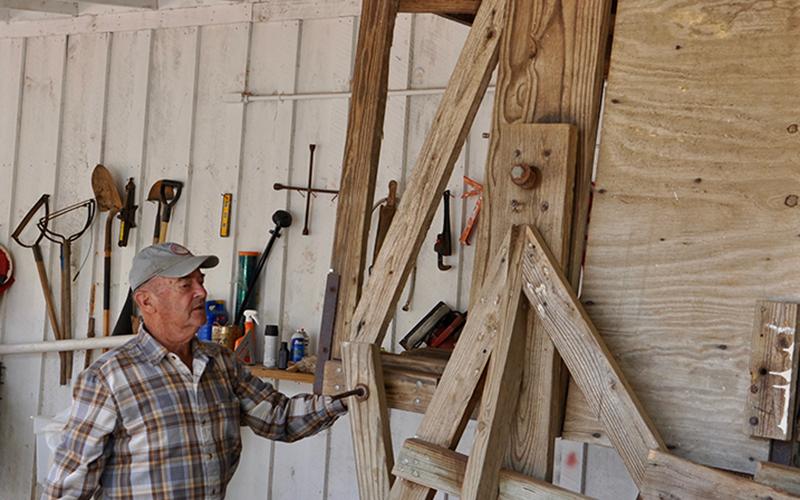 Mountain View Orchards Founder Joe Dickey gives a demonstration on how to use this apple grater that was built in the 1800s.