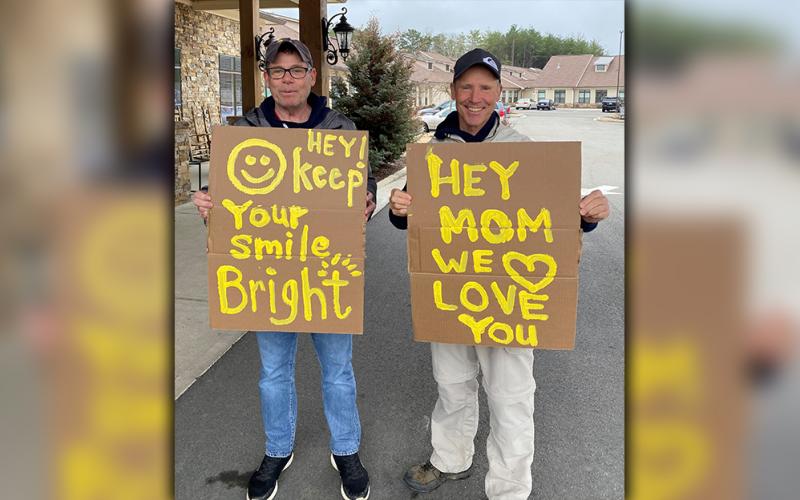 Jeff Pierce and Ryan Pierce created signs to cheer their mom, Blue Ridge Assisted Living &amp; Memory Care resident Carolyn Pierce, who is unable to receive visitors during the COVID-19 pandemic.