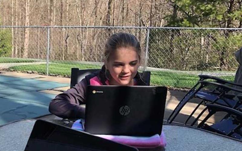 Blue Ridge Elementary School student Annaleigh Cheatham uses her school issued Chromebook to complete her digital learning.