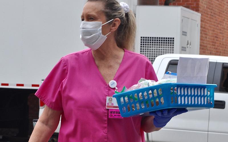 Fannin Regional Hospital Auxiliary member Janet Tishner observed the assembly line as she helped to create gift baskets for hospital employees.