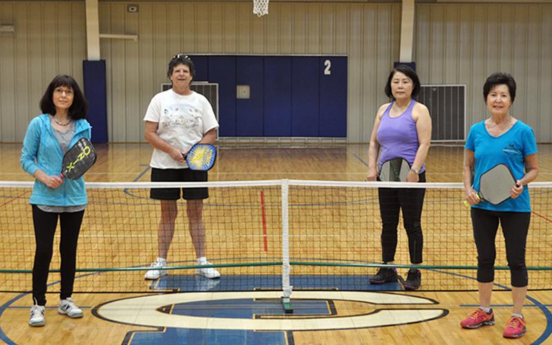 Pickleball players from left, Lynden Willits, Lori Schaltz, Kim Curry and Gail O’Neal take a break from playing pickleball for a photo at the Fannin County Recreation Center Thursday, May 7.