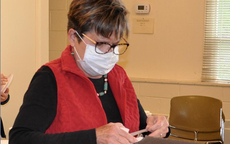 Suzanne Bienert helps create “learning kits” for the children of Fannin County’s Boys &amp; Girls Club Thursday, April 30.