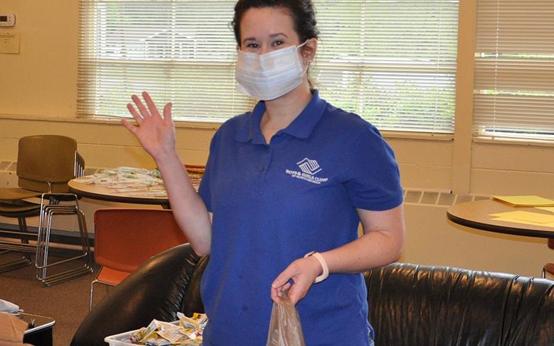 Staff members of Boys &amp; Girls Clubs of North Georgia’s Fannin County club were busy preparing “learning kits” for their children Thursday, April 30. Waving is Club Director Victoria Turner.