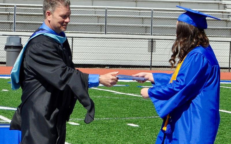 Haley Parks accepts her diploma from Fannin County High School Principal Erik Cioffi during a private graduation ceremony.