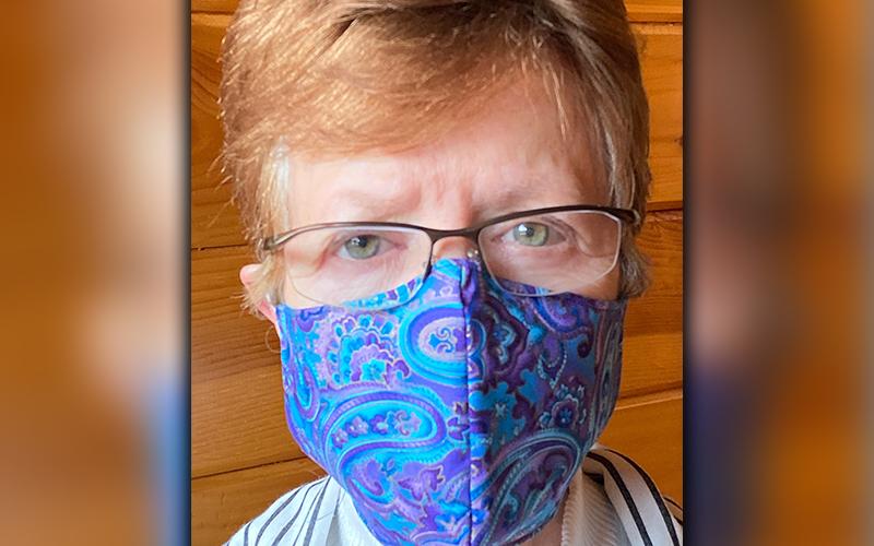 Donna Moriarty shows off her craft in a selfie. Moriarty has created around 300 masks to donate to folks without protection.