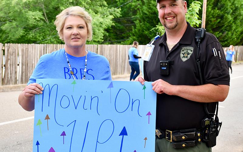 Blue Ridge Elementary School Student Information Specialist Lisa Jackson and School Resource Officer Jim Burrell celebrate the fifth graders’ transition to middle school during the school’s Fifth Grade Drive-Thru Parade Tuesday, May 19.