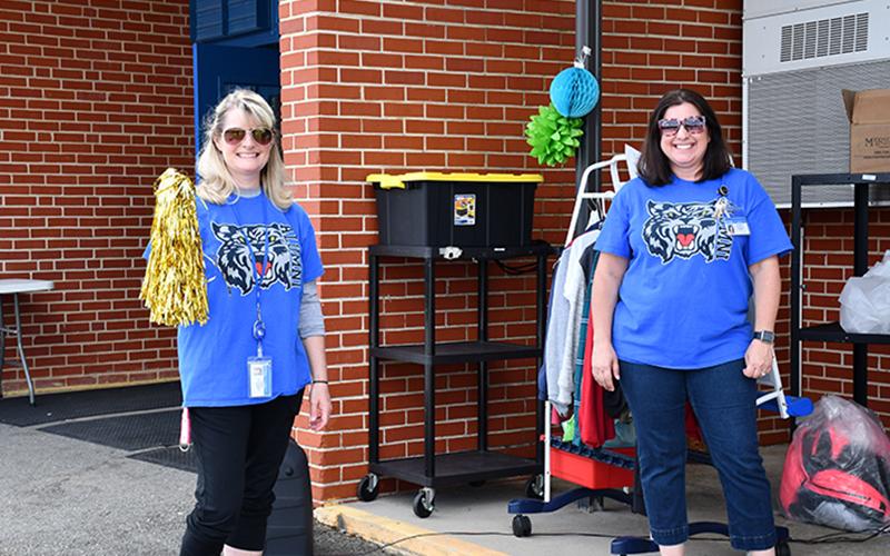 East Fannin Elementary School Physical Education Teacher Kathy Culpepper, left, and STEM Teacher Christie Holtman cheer on fifth grade students as they drive through the school’s Fifth Grade Parade Thursday, May 22.