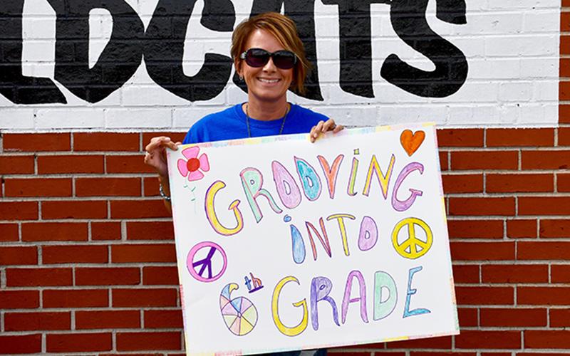 East Fannin Elementary School Third Grade Teacher Lora Robinson celebrates the school’s fifth grade students in a groovy way as they drive through the school’s Fifth Grade Parade Thursday, May 22.