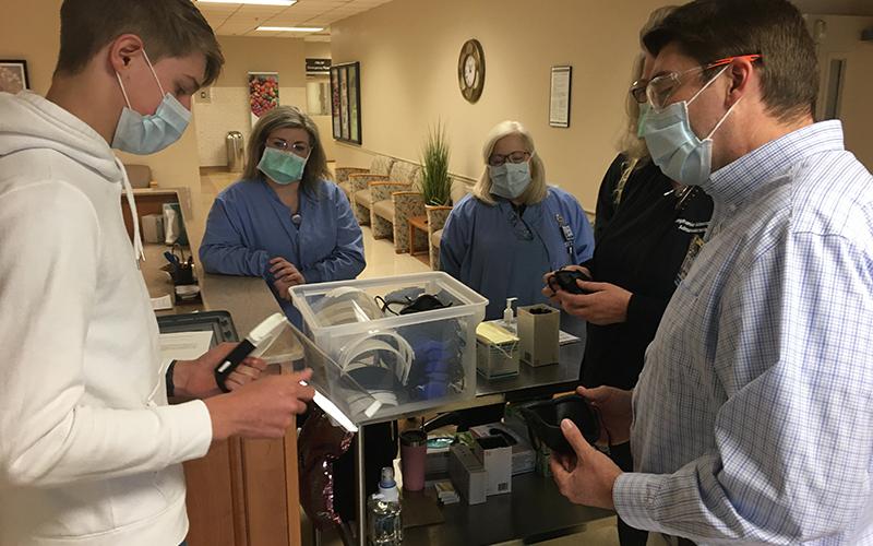 Fannin County High School student Bryce Ware discusses the Personal Protective Equipment he created with, from left, sleep technologists Holly Lowery and Debbie Sanders, Fannin Regional Executive Director of Nursing Stephanie Monico and Fannin Regional Chief Executive Officer Jason Jones.