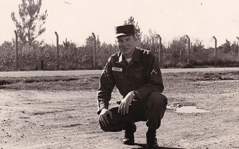 Private First Class Garnett Webb kneels in his uniform while on active duty with the U.S. Army. Webb joined the Army in 1959.