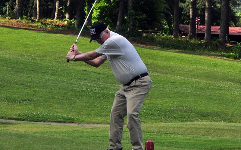 Golfer Bill Huff squares up a ball at the Copper Basin Golf Club Thursday, June 11.