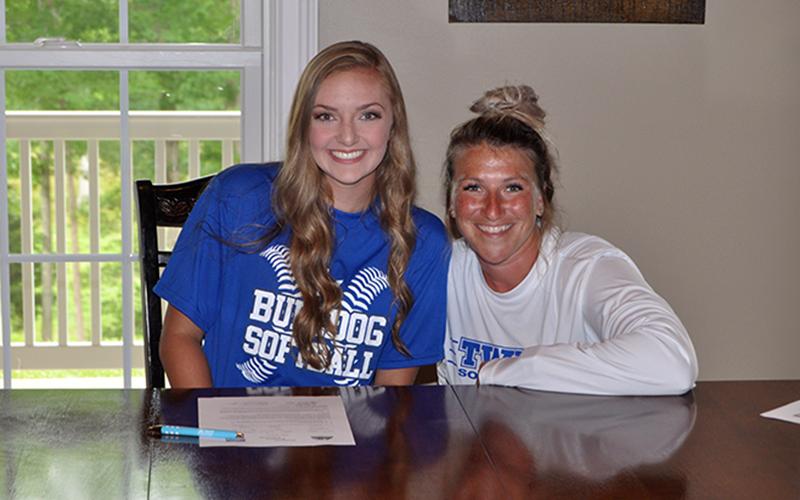 Copper Basin Lady Cougar Regan Holder signed a scholarship to play softball at Tennessee Wesleyan University Wednesday, June 17. Holder, left, smiles with TWU Assistant Coach Leah Thompson.