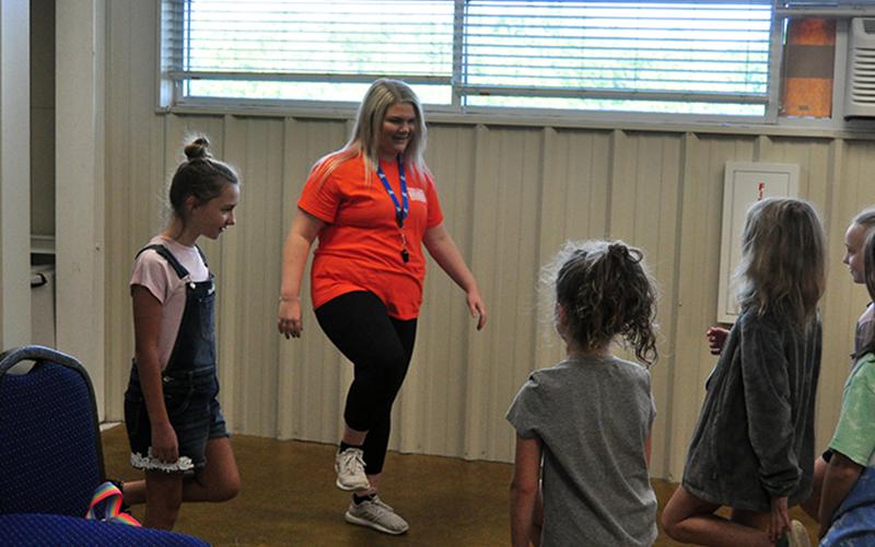 Summer Camp helper Chloe Clemmons, center, and helper Alania Hughes, left, lead a group in the game Simond Says during the Fannin County Recreation Department’s Summer Camp Wednesday, June 3.