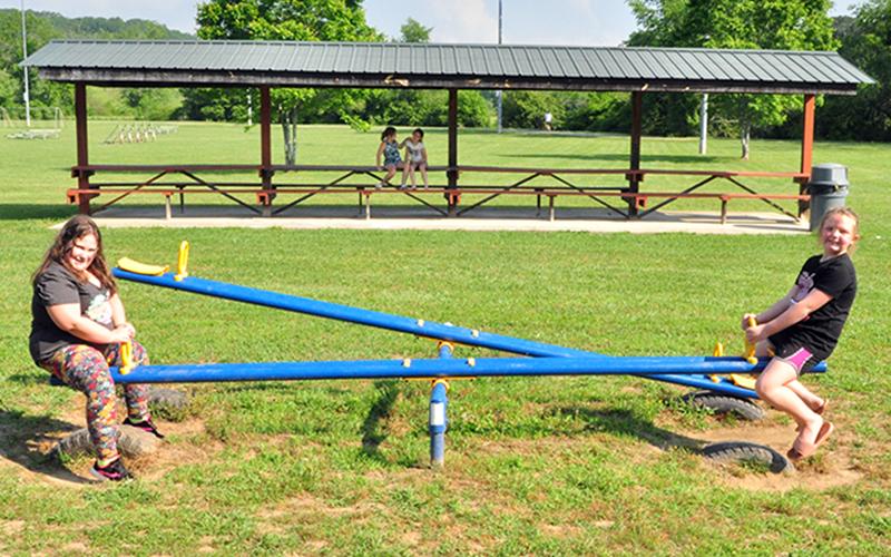Baillie Traylor, left, and Kenna Wimpey play on the seesaw at the Recreation Department’s Summer Camp Wednesday, June 3.