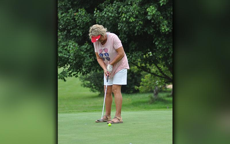 Golfer Audrey Sullivan sinks a putt during the “Stars and Stripes Shootout” golf tournament Saturday, June 27.