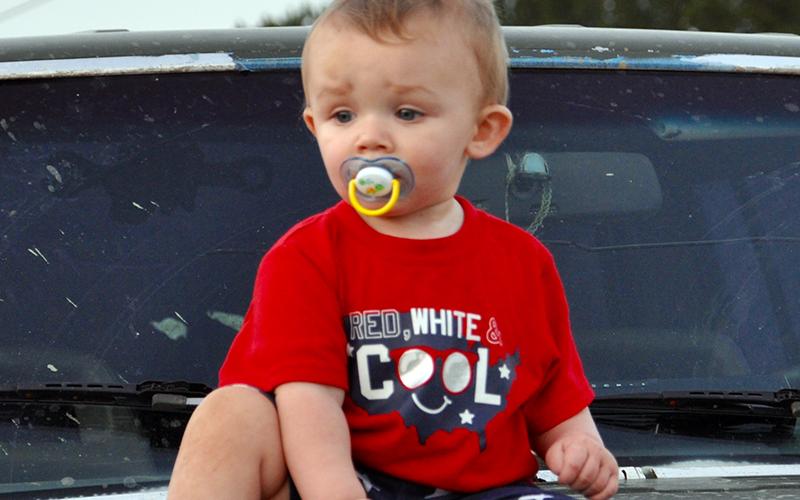August Anderson sat beside his parents on the hood of a Jeep while waiting on Ducktown’s fireworks to blast off Saturday, June 27.