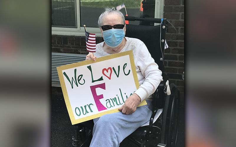 PruittHealth - Blue Ridge held a socially distanced drive-thru parade to lift the spirits of their residents Monday, May 25. Elsie Petty is shown letting the parade attendees know they love them.