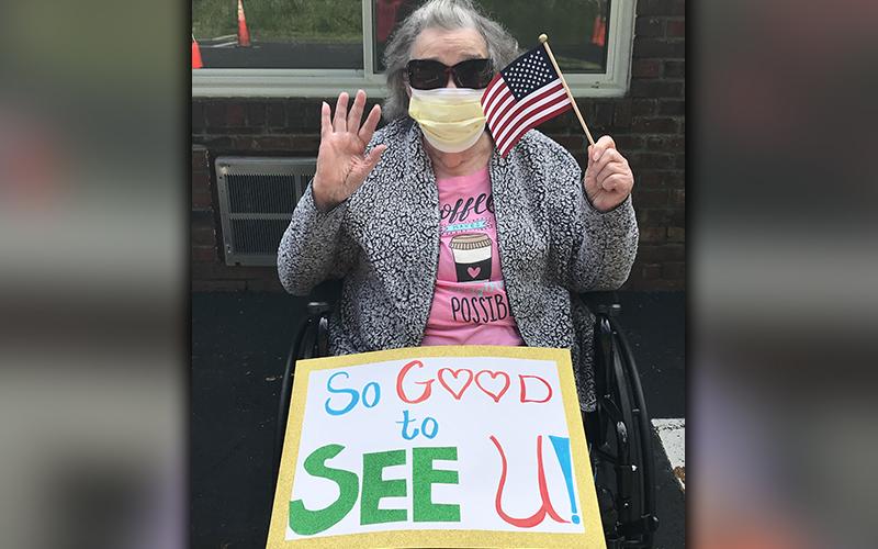 PruittHealth - Blue Ridge resident Juanita Burton held a sign expressing her excitement to see everyone during the center’s drive-thru parade on Memorial Day.