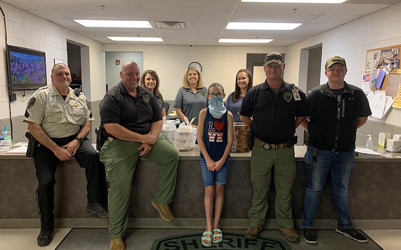 Lacey Holloway recently delivered meals to the Fannin County Sheriff’s Office as part of her effort to Back the Blue. Shown with Lacey are, from left, front, Sergeant John Bramlett, Investigator John Arp, Investigations Captain Justin Turner and intern Hayden Smith; and, back, Faith Hensley, Amber Twiggs and Jessica Lunsford.
