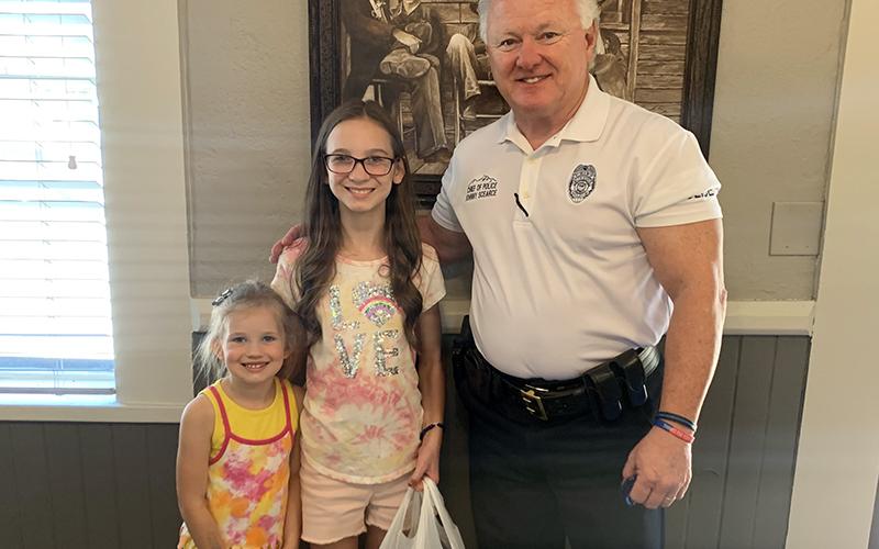 Lacey Holloway and her sister, Londyn, delivered meals for the Blue Ridge Police Department to Chief Johnny Scearce.