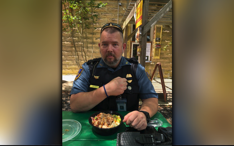 McCaysville Police Officer Cory Collogan shows off his Back the Blue bracelet made by Lacey Holloway as he prepares to eat a meal donated through the McCaysville youngster’s efforts to show appreciation to law enforcement officers.