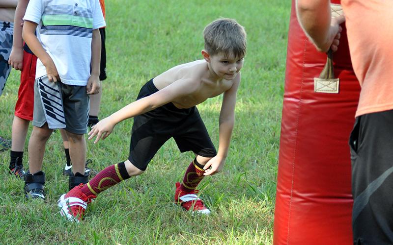 Camdon Sawyer practices his tackling during the Copper Basin Youth Sports football conditioning Thursday, July 16.