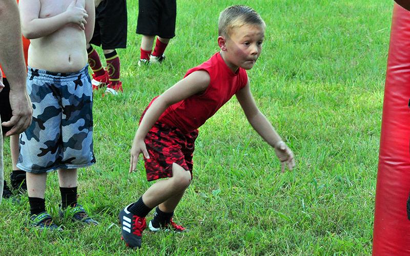 Cutler Curtis gets down in his three-point-stance during Copper Basin’s youth football conditioning Thursday, July 16.