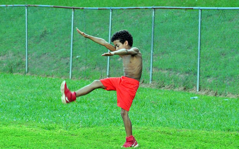 Kayden Loudermilk loosens up during the Copper Basin youth sports football conditioning Thursday, July 16.