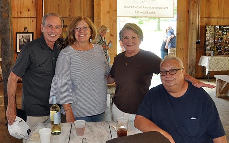 People started gathering around with their favorite drink and waited for the show to start at the Freedom For Fido fundraiser Thursday, July 23. Shown are, from left, Joe Lerro, Denice Vogel, Patsi Brantley and Ed Brantley.