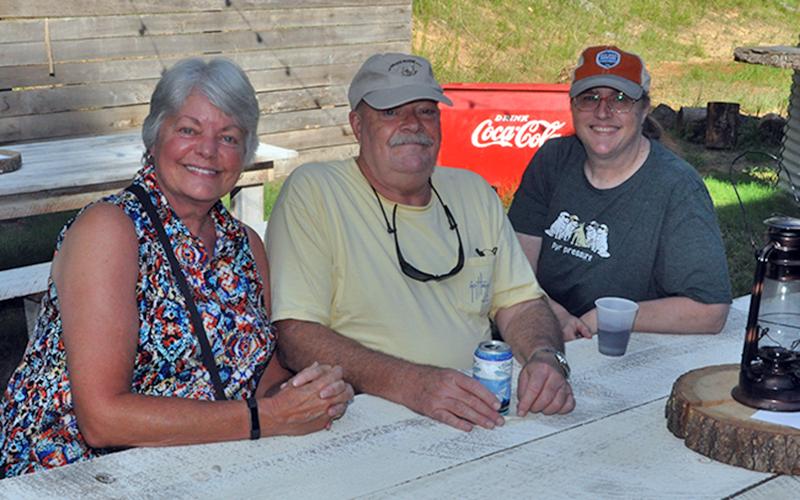 Shown, from left, Lelsie McGonegal, Errol McGonegal and Michelle Degner wait patiently on the show to start during the Freedom For Fido fundraiser event Thursday, July 23. Degner was the first recipient of a fence for her dog paid for by Freedom For Fido.