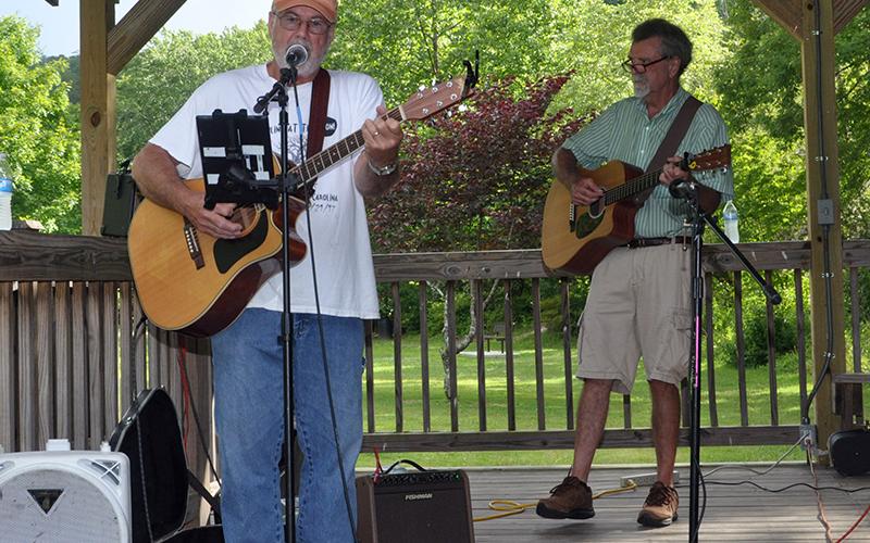 Dan Adams sings and plays his guitar during Pickin’ in the Park, Thursday, June 9.