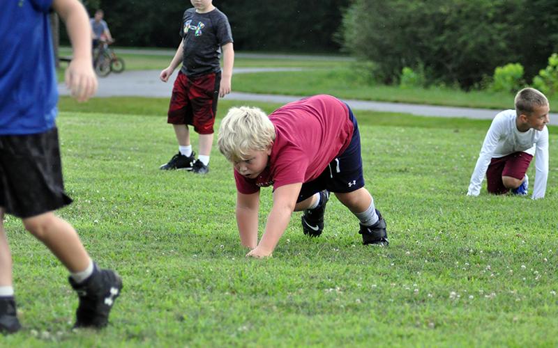 Zion Wood bear crawls to get warmed up at the start of Fannin’s six and seven year old football practice Tuesday, July 21.