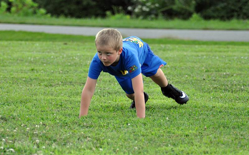 Jonah Johnson focuses on the coach during Fannin’s rec league football practice Tuesday, July 21.