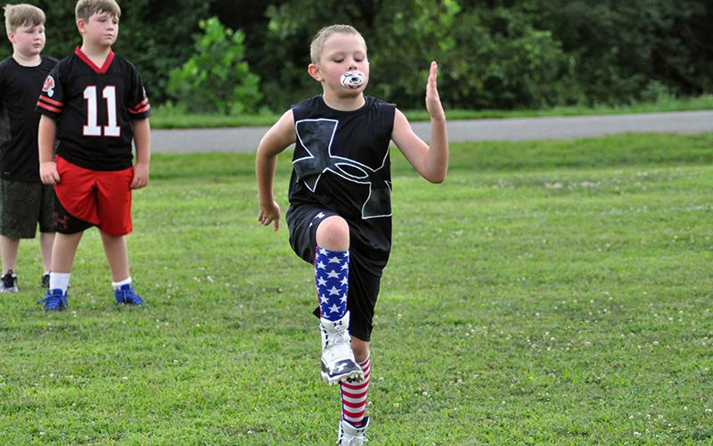 Kylan Geller limbers up during warm-ups at the Fannin County Recreation Center football practice Tuesday, July 21.