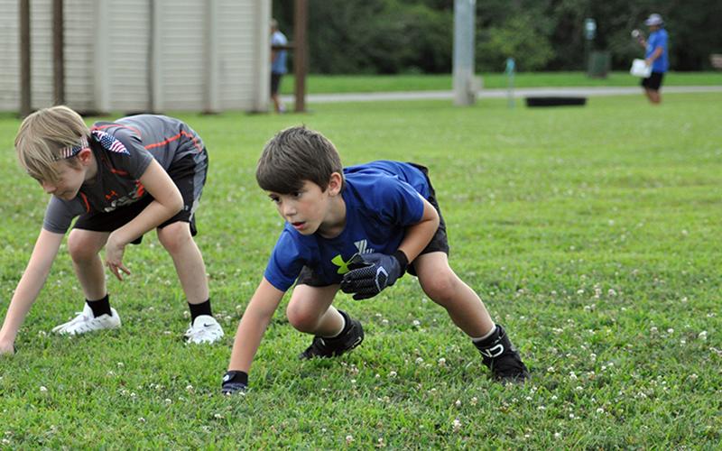 Kyle Allen works on his three-point stance during football practice at the Fannin Recreation Center Tuesday, July 21.