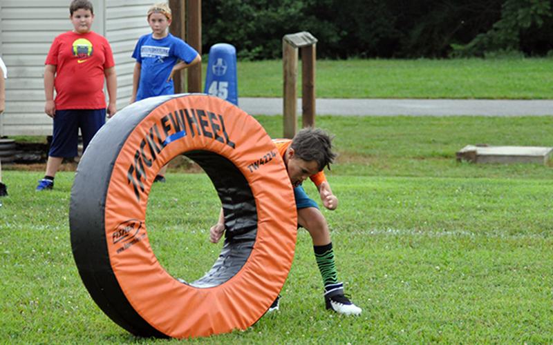 Evander Patterson works on his tackling during football practice at the rec center Tuesday, July 21.