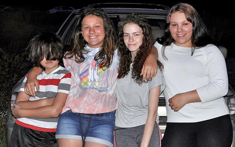 People gathered and waited for McCaysville’s fireworks show to light up the sky Friday, July 3. Shown are, from left, Trent Stuart, Seanna Allen, Trinity Stuart and Hannah Allen.