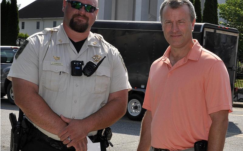 Fannin County Deputy Sheriff John Kinser, left, stands beside Sheriff Dane Kirby before the commencement of the Mountain Patriots’ Public Prayer Rally Saturday, July 18. The meeting was meant to pray for the nation, law enforcement officers and first responders.