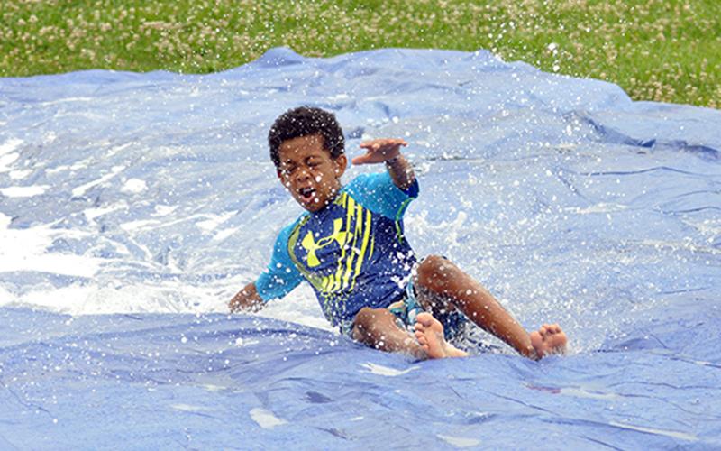 Jamari Dunn enjoys the slip-n-slide during water day at the Fannin Recreation Center’s  summer camp, Wednesday, July 8.