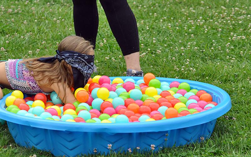 Payton Deal searches for a prize in a small pool during the Fannin Recreation Center‘s summer camp, Wednesday, July 8.